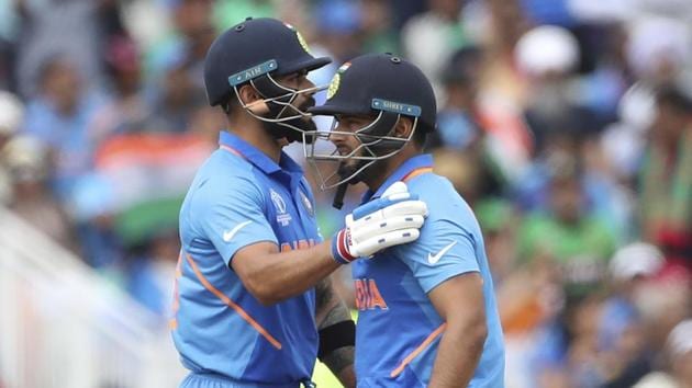 India's captain Virat Kohli, left, pats teammate Rishabh Pant(AP)