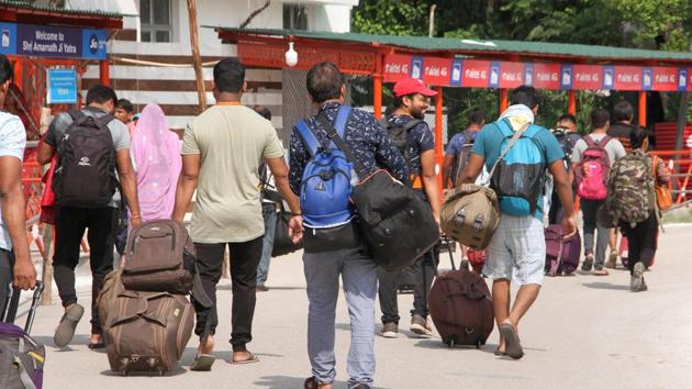 Amarnath pilgrims at a base camp after the Yatra was suspended in Jammu, Saturday, Aug 3, 2019. The Jammu and Kashmir government on Friday asked Amarnath Yatris and tourists to immediately make necessary arrangements to cut short their stay in the Valley and return as soon as possible in the wake of intelligence inputs of "specific terror threats" to the pilgrimage.(PTI)