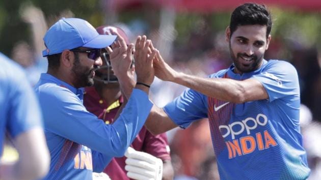 India's Bhuvneshwar Kumar, right, is congratulated after taking the wicket of West Indies' Evin Lewis. (AP)