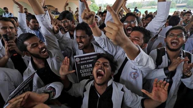 Medical students shout slogans during a protest against National Medical Commission (NMC) Bill, which they say will result in deterioration of medical studies and services, in New Delhi.(REUTERS)