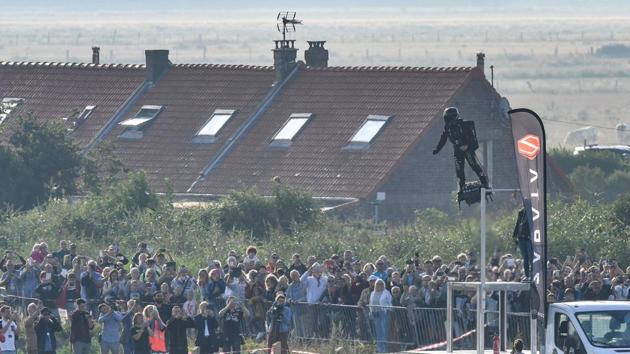 Zapata on his jet-powered “flyboard” takes off from Sangatte. Zapata has been working on the hoverboard for the past three years, despite losing parts of two fingers during its maiden flight in his garage near Marseille, when they got sucked into the turbines. (Denis Charlet / AFP) Zapata on his jet-powered “flyboard” takes off from Sangatte. Zapata has been working on the hoverboard for the past three years, despite losing parts of two fingers during its maiden flight in his garage near Marseille, when they got sucked into the turbines. (Denis Charlet / AFP)