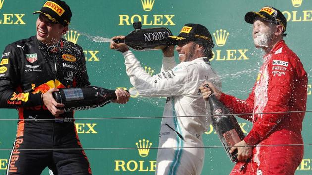 Mercedes driver Lewis Hamilton, center, of Britain, winner of the Hungarian Formula One Grand Prix. (AP) Mercedes driver Lewis Hamilton, center, of Britain, winner of the Hungarian Formula One Grand Prix. (AP)