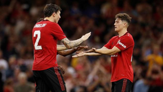 Manchester United's Daniel James celebrates with teammates after scoring the winning penalty.(Action Images via Reuters)