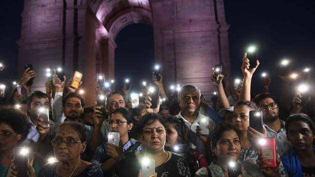 Indian social activists use their mobile light as they take part in a solidarity rally in front of India Gate monument for the Unnao rape victim in New Delhi. A teenager who accused a senior politician of rape is fighting for her life after being critically injured in a crash on July 28, 2019 that killed two relatives, raising suspicions of foul play. (Sajjad Hussain / AFP) Indian social activists use their mobile light as they take part in a solidarity rally in front of India Gate monument for the Unnao rape victim in New Delhi. A teenager who accused a senior politician of rape is fighting for her life after being critically injured in a crash on July 28, 2019 that killed two relatives, raising suspicions of foul play. (Sajjad Hussain / AFP)