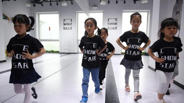 Children training at a modelling school in Beijing. (AFP) Children training at a modelling school in Beijing. (AFP)