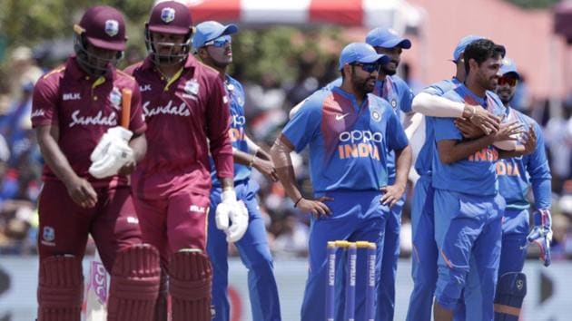 India's Bhuvneshwar Kumar, right, is congratulated after taking the wicket of West Indies' Evin Lewis. (AP) 