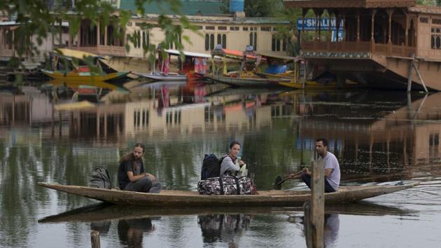 Foreign tourists cross the Dal Lake on a shikara as they prepare to leave Srinagar. Australia, Germany and the United Kingdom asked their citizens to avoid all travel to Jammu and Kashmir, a day after the government asked tourists and Amarnath Yatra pilgrims to “immediately” cut short their stay and return, in an unprecedented advisory amid intelligence inputs of terror threats. (Dar Yasin / AP)