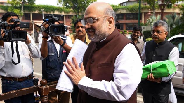 Union Home Minister Amit Shah arrives at the Parliament house in New Delhi on August 05. On Monday, Amit Shah moved a resolution in Rajya Sabha to abrogate Article 370 of the Constitution that extends special status to Jammu and Kashmir. The Rajya Sabha also cleared a bill to divide the state into two union territories, one for Ladakh and the second for Jammu and Srinagar regions. Both would be administered by the central government through a Lt-Governor. (Prakash Singh / AFP)