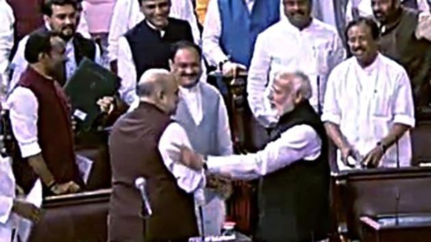 Prime Minister Narendra Modi greets Union Home Minister Amit Shah after the Jammu and Kashmir Reorganisation Bill being passed by Rajya Sabha.(ANI) Prime Minister Narendra Modi greets Union Home Minister Amit Shah after the Jammu and Kashmir Reorganisation Bill being passed by Rajya Sabha.(ANI)