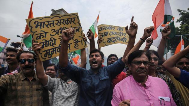 People raise slogans as they celebrate the government’s scrapping of the special status for Kashmir, in Ahmedabad. Such images have been pouring in through the day from across the country. (Amit Dave / REUTERS)