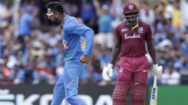 India's Krunal Pandya, left, reacts after taking the wicket of West Indies' Rovman Powell. (AP)