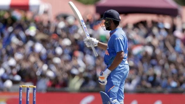 India's Rohit Sharma raises his bat after scoring 50 runs. (AP) 