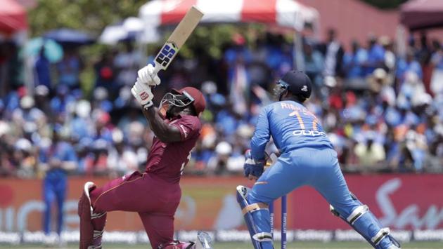 West Indies' Rovman Powell, left, hits a six. (AP) 