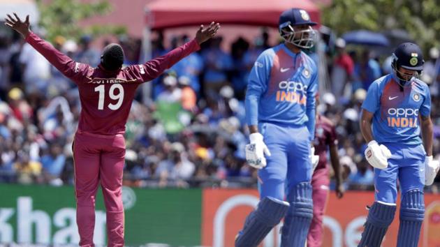 West Indies' Sheldon Cottrell, left, celebrates after taking the wicket of India's Manish Pandey. (AP) 