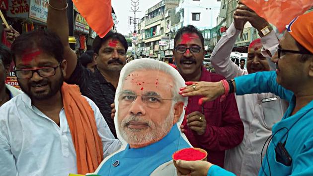 A BJP supporter celebrates the scrapping of Article 370 from Jammu and Kashmir, Varanasi, August 5, 2019(ANI) A BJP supporter celebrates the scrapping of Article 370 from Jammu and Kashmir, Varanasi, August 5, 2019(ANI)
