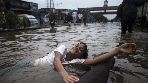 Mumbai, India - Aug. 4, 2019: A boy plays on the flooded street due to heavy rain on LBS Road near Sion station in Mumbai, India, on Sunday, August 4, 2019. (Photo by Pratik Chorge/Hindustan Times) (Pratik Chorge/HT Photo) Mumbai, India - Aug. 4, 2019: A boy plays on the flooded street due to heavy rain on LBS Road near Sion station in Mumbai, India, on Sunday, August 4, 2019. (Photo by Pratik Chorge/Hindustan Times) (Pratik Chorge/HT Photo)