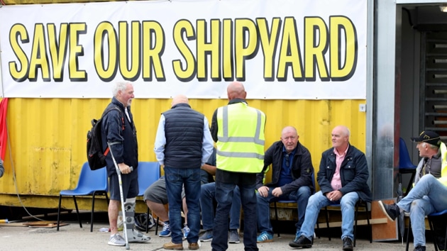 They emerged from a meeting chanting “save our shipyard” before confirming the outcome of the vote.(AFP image) They emerged from a meeting chanting “save our shipyard” before confirming the outcome of the vote.(AFP image)