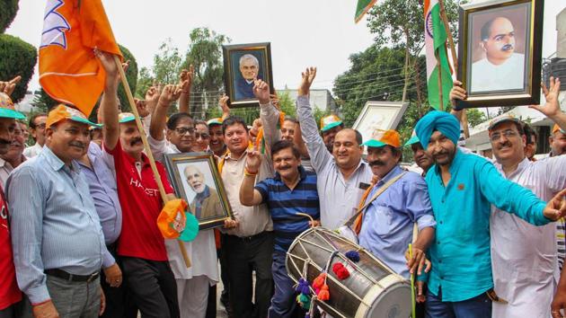 Bharatiya Janata Party (BJP) workers celebrate the government’s decision to revoke Article 370 that gave special status to Jammu and Kashmir and a separate bill to bifurcate the state into two separate union territories of Jammu and Kashmir and Ladakh, in Jammu. (PTI) Bharatiya Janata Party (BJP) workers celebrate the government’s decision to revoke Article 370 that gave special status to Jammu and Kashmir and a separate bill to bifurcate the state into two separate union territories of Jammu and Kashmir and Ladakh, in Jammu. (PTI)