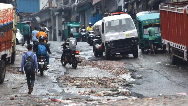 Jet Pot holes created due to heavy rain in the early hours of the morning at Anand Parbat in New Delhi. (Sanchit Khanna / HT Photo) 