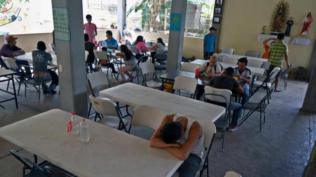 Migrants eat and rest at La Casa del Caminante shelter. “Many prefer to go deeper into the jungle and the mountains to get here because both the police and criminals will rob them,” said Sister Maria Tello, director of the Casa del Caminante refuge located close to the Palenque train stop. (Alfredo Estrella / AFP) Migrants eat and rest at La Casa del Caminante shelter. “Many prefer to go deeper into the jungle and the mountains to get here because both the police and criminals will rob them,” said Sister Maria Tello, director of the Casa del Caminante refuge located close to the Palenque train stop. (Alfredo Estrella / AFP)