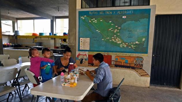 Honduran migrant Cesar Caballero and family eat at La Casa del Caminante shelter. Sister Maria says she doesn’t know which routes exactly the migrants take “but even if we knew them, we wouldn’t divulge them because that would put (the migrants) in danger.” She said migrants arrive “badly hurt and tired,” with viral diseases and dehydrated due to the long routes through inhospitable terrain. (Alfredo Estrella / AFP) Honduran migrant Cesar Caballero and family eat at La Casa del Caminante shelter. Sister Maria says she doesn’t know which routes exactly the migrants take “but even if we knew them, we wouldn’t divulge them because that would put (the migrants) in danger.” She said migrants arrive “badly hurt and tired,” with viral diseases and dehydrated due to the long routes through inhospitable terrain. (Alfredo Estrella / AFP)