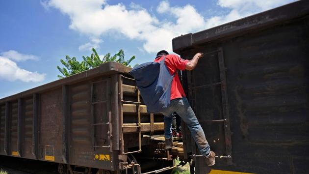 A migrant gets on La Bestia. One needs to pay $26 to be taken across 20 miles (33 kilometers) of national park from El Naranjo in Guatemala to the Mexican frontier. The price jumped to $42 for the onward 40-mile trip to Tenosique, in Mexico, where migrants can jump on the train “La Bestia.” (Alfredo Estrella / AFP) A migrant gets on La Bestia. One needs to pay $26 to be taken across 20 miles (33 kilometers) of national park from El Naranjo in Guatemala to the Mexican frontier. The price jumped to $42 for the onward 40-mile trip to Tenosique, in Mexico, where migrants can jump on the train “La Bestia.” (Alfredo Estrella / AFP)