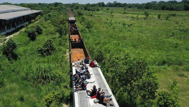 Migrants onboard a train known as “The Beast” in Palenque, Chiapas state, Mexico. The illegal crossing of Hondurans, Salvadoreans and Guatemalans to Mexico increased significantly since October but migratory controls have postponed the “American dream” of migrant families. The journey northwards is becoming ever more treacherous since Mexico deployed thousands of troops to its border with Guatemala, which has also signed a pact with Washington aimed at keeping migrants out of the US. (Alfredo Estrella / AFP) Migrants onboard a train known as “The Beast” in Palenque, Chiapas state, Mexico. The illegal crossing of Hondurans, Salvadoreans and Guatemalans to Mexico increased significantly since October but migratory controls have postponed the “American dream” of migrant families. The journey northwards is becoming ever more treacherous since Mexico deployed thousands of troops to its border with Guatemala, which has also signed a pact with Washington aimed at keeping migrants out of the US. (Alfredo Estrella / AFP)