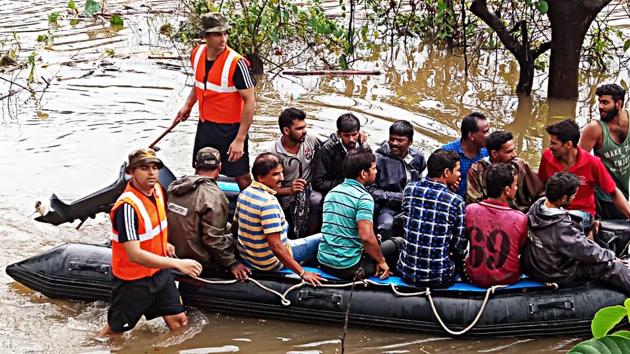 Team of Indian Navy rescue residents after incessant rainfall near Kadra Dam in Karnataka.(ANI Photo)