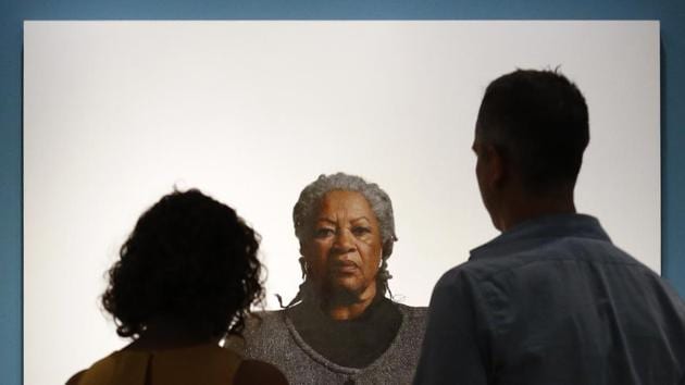 Visitors view a portrait of Toni Morrison, by the artist Robert McCurdy at the National Portrait Gallery in Washington. Morrison, a pioneer and giant of modern literature whose imaginative power in ‘Beloved,’ ‘Song of Solomon’ and other works transformed American letters by dramatizing the pursuit of freedom within the boundaries of race, died aged 88 following a brief illness. (Patrick Semansky / AP)