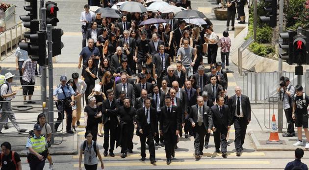 Lawyers cross a street during a protest march in Hong Kong on Wednesday.(AP)