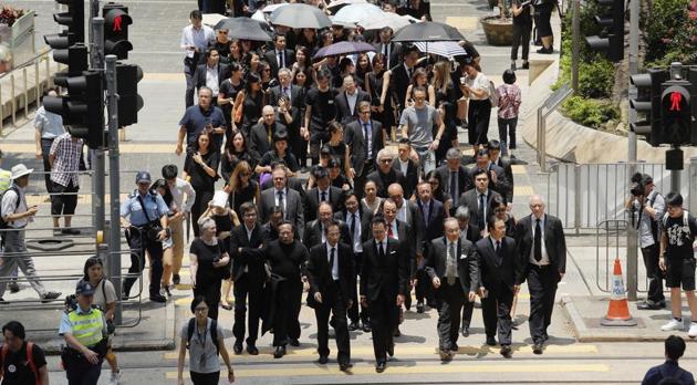 Lawyers cross a street during a protest march in Hong Kong on Wednesday. (AP) Lawyers cross a street during a protest march in Hong Kong on Wednesday. (AP)