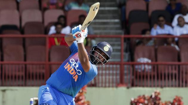 India's Rishabh Pant hits out to score the winning run as West Indies wicketkeeper Nicholas Pooran looks on during their third T20 international cricket match in Providence, Guyana, Tuesday, Aug. 6, 2019. India won by seven wickets.(AP)