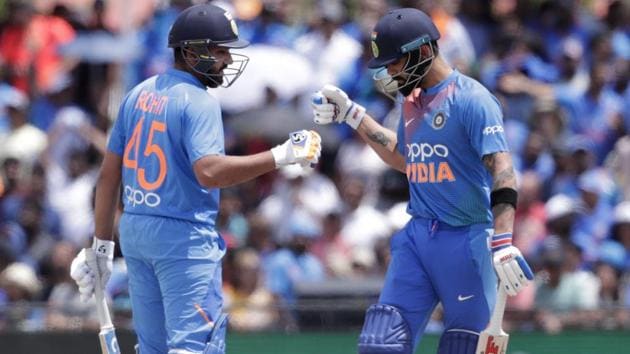 Rohit Sharma, left, bumps fist with Virat Kohli during the match against West Indies.(AP)