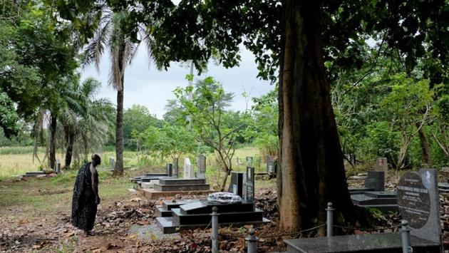 Nana Assenso stands at the grave of his uncle, remembering the man he loved but also a past that has haunted his family for generations. Though he followed the family tradition and named his youngest son Kwame Badu. (Francis Kokoroko / REUTERS) Nana Assenso stands at the grave of his uncle, remembering the man he loved but also a past that has haunted his family for generations. Though he followed the family tradition and named his youngest son Kwame Badu. (Francis Kokoroko / REUTERS)