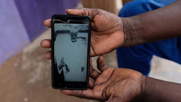 Abdul Sumud Shaibu, 50, shows a photograph of his grandfather on his mobile phone, in Obuasi. “My ancestors were giants,” he said. “They were well-built and strong. Look at the height of my grandfather in this picture.” They did battle with slave raiders, he says. In those fights, sometimes they lost. And sometimes they were captured into slavery. (Francis Kokoroko / REUTERS) Abdul Sumud Shaibu, 50, shows a photograph of his grandfather on his mobile phone, in Obuasi. “My ancestors were giants,” he said. “They were well-built and strong. Look at the height of my grandfather in this picture.” They did battle with slave raiders, he says. In those fights, sometimes they lost. And sometimes they were captured into slavery. (Francis Kokoroko / REUTERS)