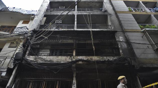 People and police personnel gathered around the building in south Delhi’s Zakir Nagar where a fire broke out in the early hours of Tuesday, August 6, 2019. (Burhaan Kinu/HT PHOTO) People and police personnel gathered around the building in south Delhi’s Zakir Nagar where a fire broke out in the early hours of Tuesday, August 6, 2019. (Burhaan Kinu/HT PHOTO)