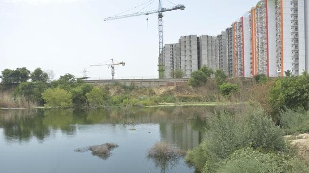 Ghaziabad, India - June 28, 2019: A view of the pond where three minor boys drowned, near the Bharat City highrise in Ghaziabad, India on Friday June 28, 2019. A magisterial inquiry by SDM, Loni has held the officials of Bharat City project responsible for releasing waste water into nearby trenches in Loni where the boys drowned on June 27. (Photo By Sakib Ali /Hindustan Times)