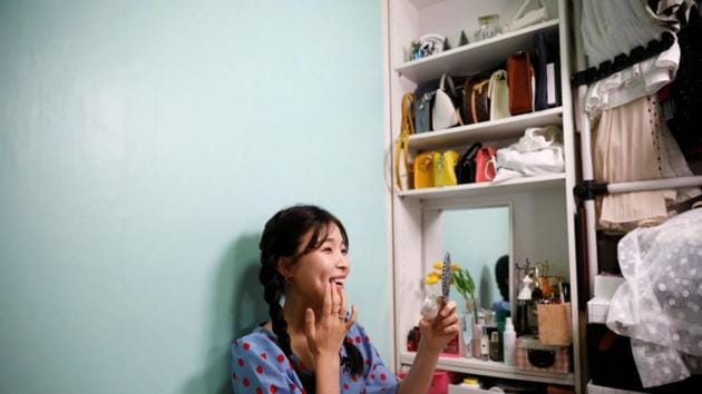Kang Na-ra, a North Korean defector who is now a beauty YouTuber, puts on her makeup with North Korean cosmetic products, in Seoul, South Korea.(REUTERS)