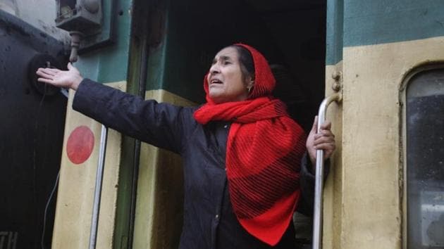 A passenger from India gestures to her relatives as she leaves by Samjhauta Express train at the railway station in Lahore, Pakistan March 4, 2019.(REUTERS)