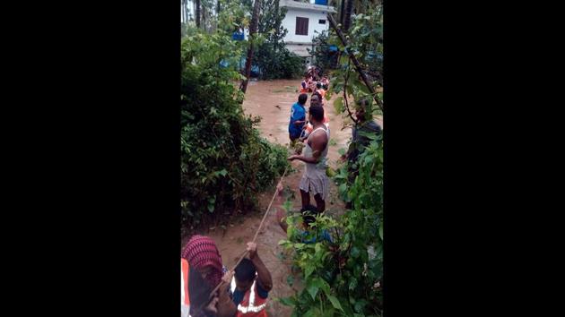 National Disaster Response Force (NDRF) personnel rescue marooned residents on the submerged areas at Nilambur and Perinthalmanna of Malappuram district. (ANI)