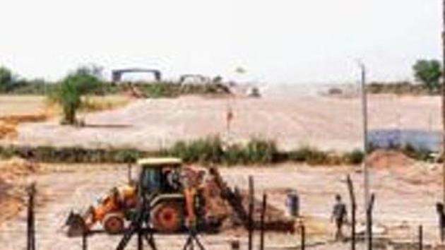 Heavy machines at work beyond the border fence for the construction of the Indian side of Kartarpur (PTI) Heavy machines at work beyond the border fence for the construction of the Indian side of Kartarpur (PTI)