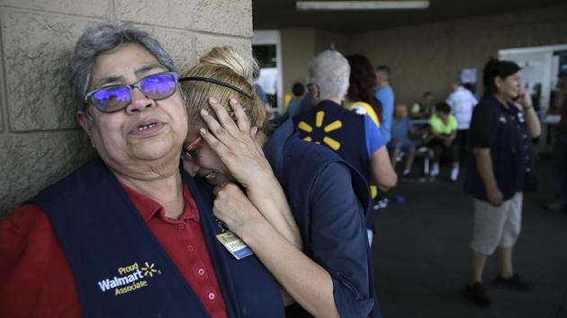 Walmart employees react after an active shooter opened fire at the store in El Paso, Texas, USA. (Mark Lambie / The El Paso Times via AP)