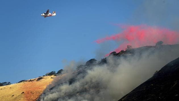 An air tanker drops retardant while battling the Marsh Fire near the town of Brentwood in Contra Costa County, California, USA. (Noah Berger / AP)