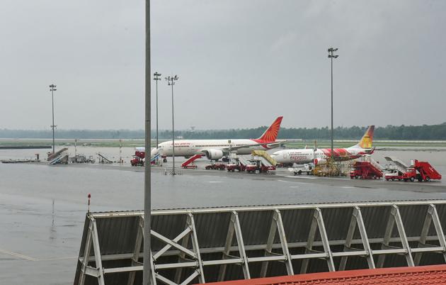 Planes stand parked at Cochin International Airport as all operations were suspended following waterlogging in the runway area.(PTI Photo)