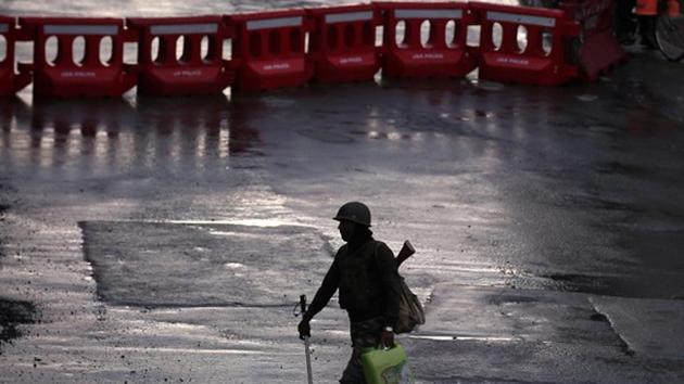 A security force personnel patrols a deserted road during restrictions in Srinagar.(REUTERS)