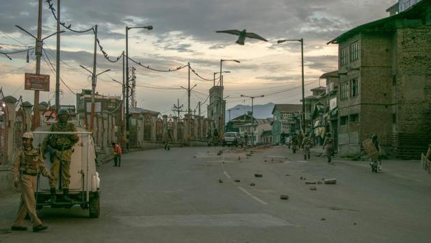 Security personnel walking on a street in Srinagar on Friday. (AFP) Security personnel walking on a street in Srinagar on Friday. (AFP)