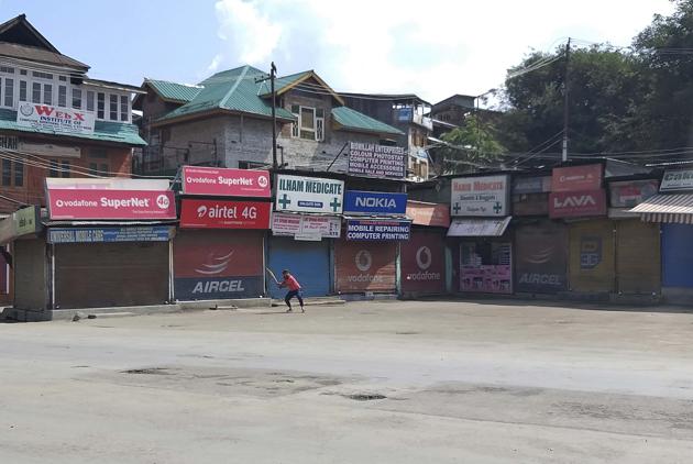 A Kashmiri plays cricket in a deserted area during curfew in Srinagar, Kashmir, Thursday, Aug. 8, 2019.(AP)