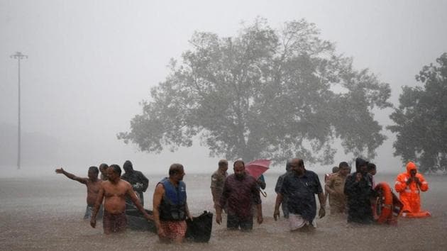 Members of a rescue team wade through a water-logged area during heavy rains on the outskirts of Kochi. Strong winds gusting up to 40-50 kmph, are likely to prevail over the Arabian Sea and along and off the West Coast and the Indian Meteorological Department has advised fishermen not to venture into these areas. (Sivaram V / REUTERS)