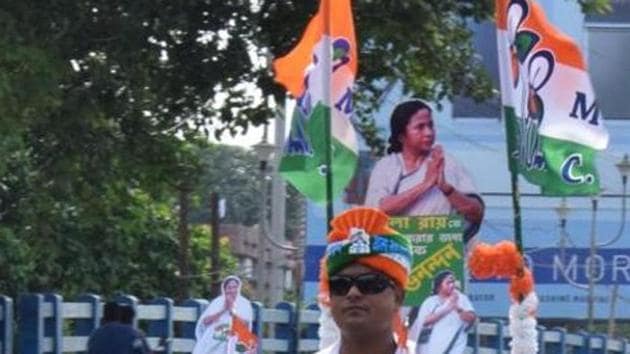 A TMC supporter rides a scooty with a cut-out of West Bengal Chief Minister Mamta Banerjee and party flag on it in Kolkata on Thursday.(ANI Photo)