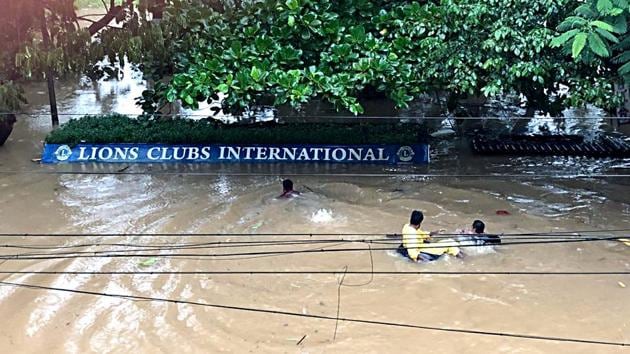 People move on a makeshift boat with car tyres on the submerged street at Nilambur. The respite is not in sight yet, as the Met Office issued a red code warning early today for the states along the western coast. (ANI)